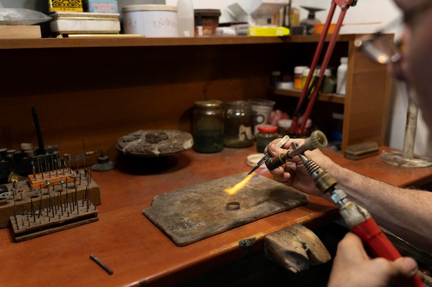 Free photo jewelry maker working alone in the atelier