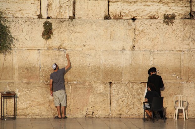 Jewish people praying to the Jerusalem's western wall