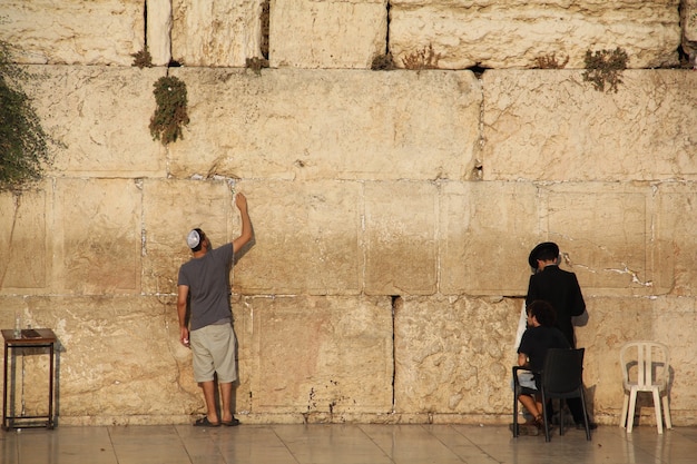 Jewish people praying to the Jerusalem's western wall