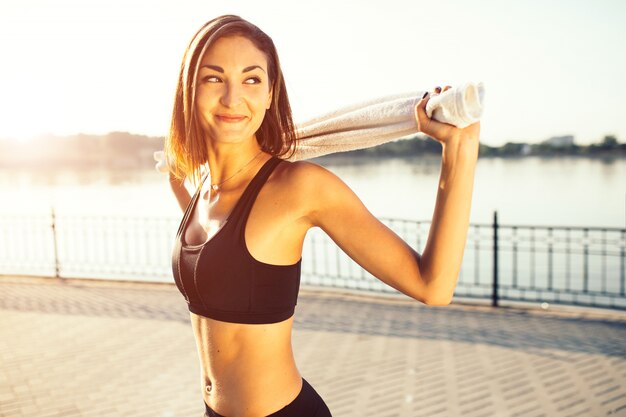 Jogger by the lake at sunset