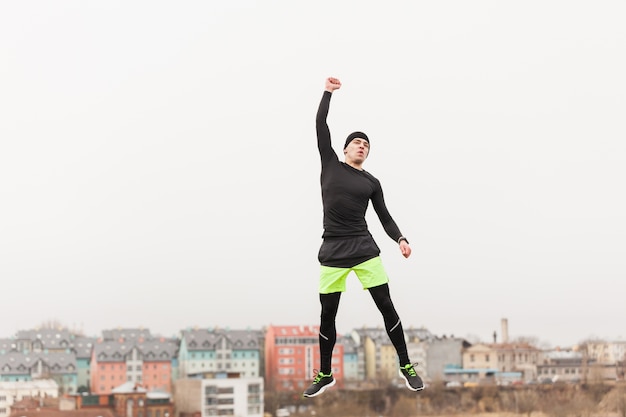 Free photo jogger raising fist