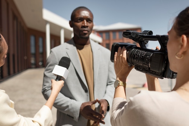 Journalist taking an interview from a man