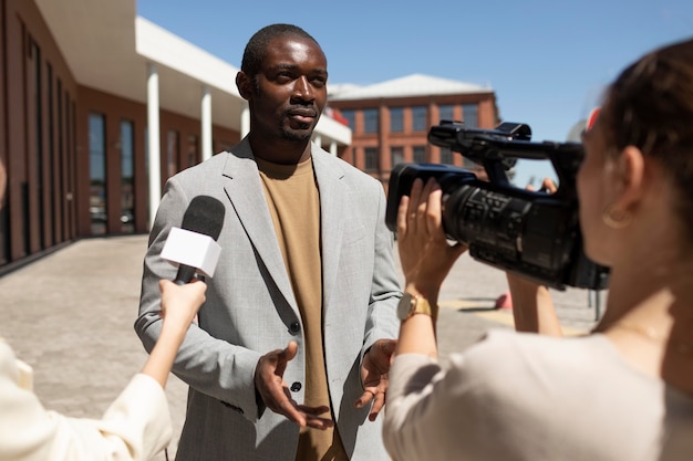 Journalist taking an interview from a man