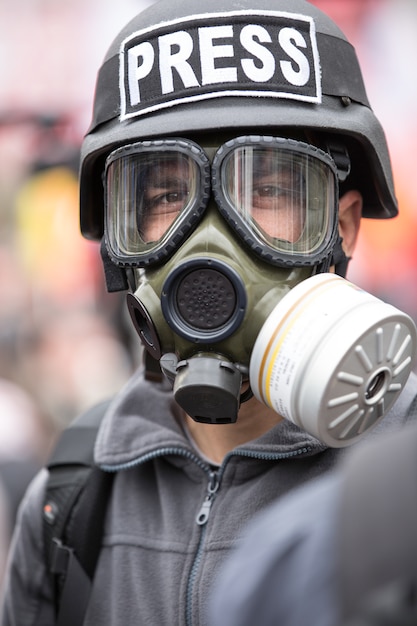 Journalist with a gas mask