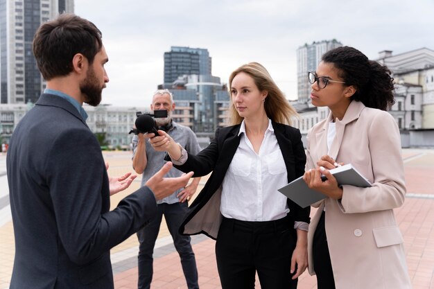 Journalists taking an interview outdoors