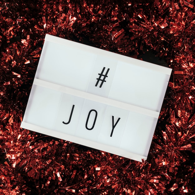 Free photo joy hashtag text with red tinsel