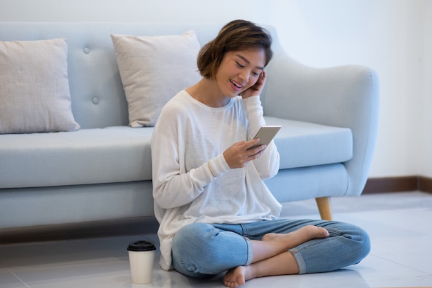 Joyful asian girl having video call