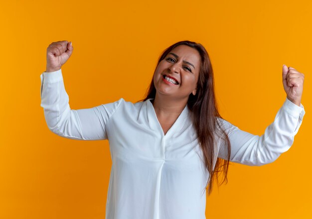 Joyful casual caucasian middle-aged woman doing strong gesture 