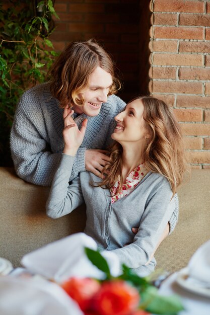 Joyful couple hugging and flirting