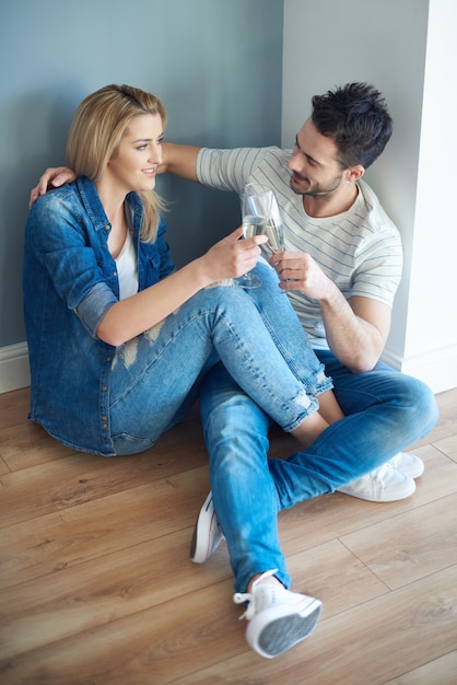 Joyful couple taking break from unpacking