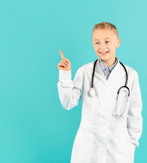 Free photo joyful doctor pointing at copy space