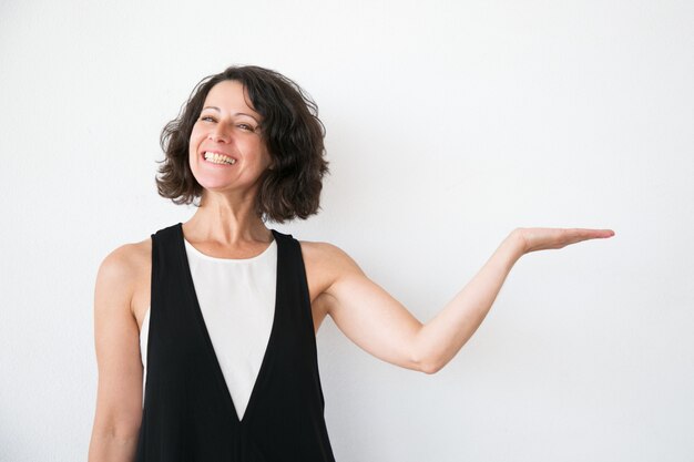 Joyful excited woman in casual presenting information