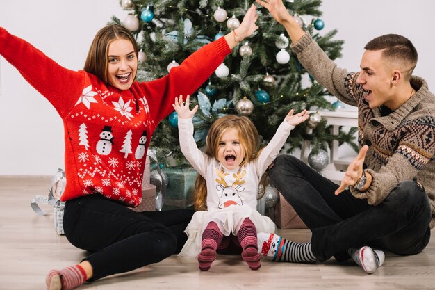 Joyful family celebrating christmas at home