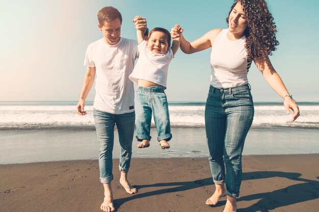 Joyful family playing on coast