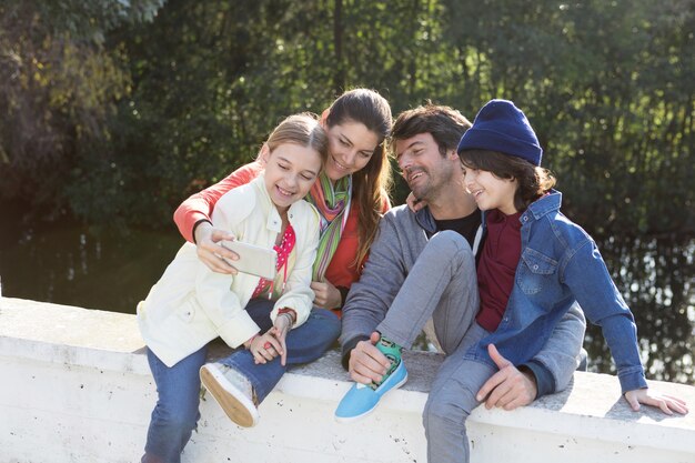 Free photo joyful family taking selfie