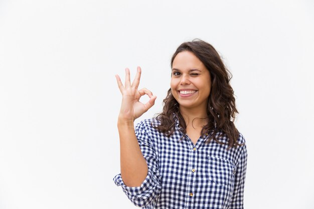 Joyful female customer making OK gesture