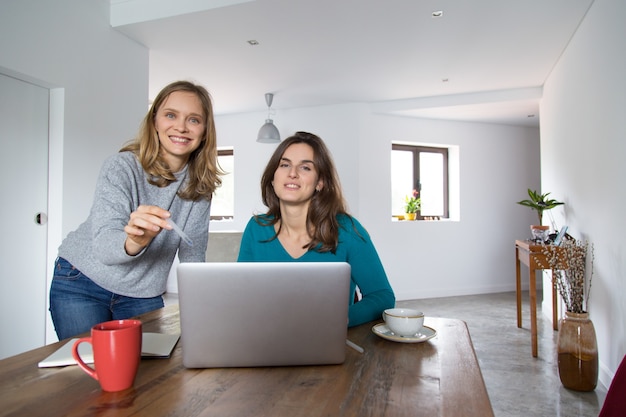 Joyful female customers enjoying shopping online