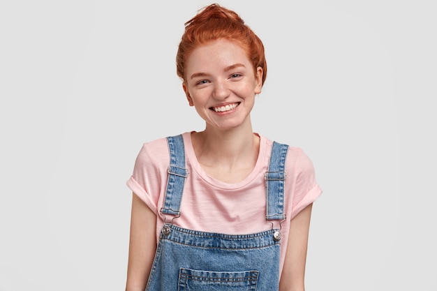 Joyful freckled young female with shining smile