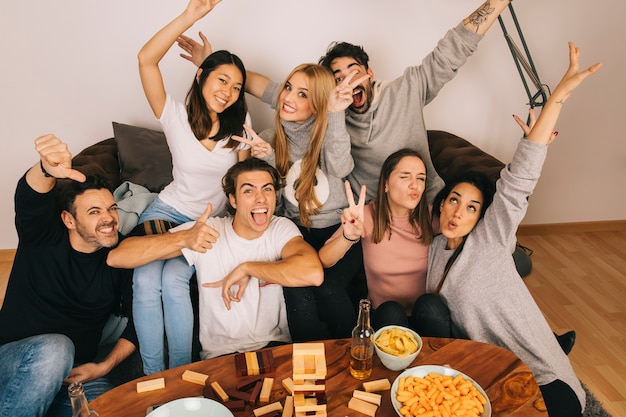 Joyful friends posing in living room