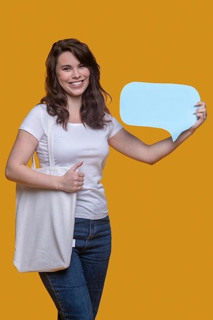 Joyful girl showing question sign before the camera