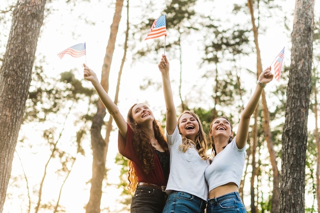 Joyful girls in nature with american flags