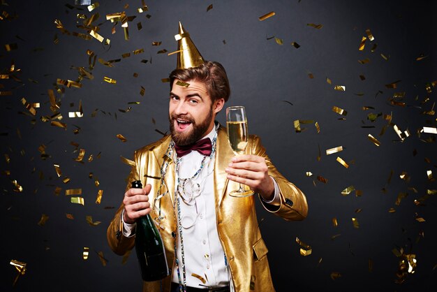 Joyful man drinking a champagne