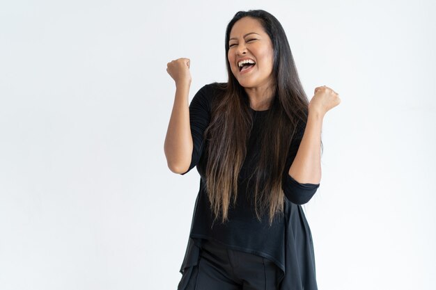 Joyful middle-aged woman celebrating success