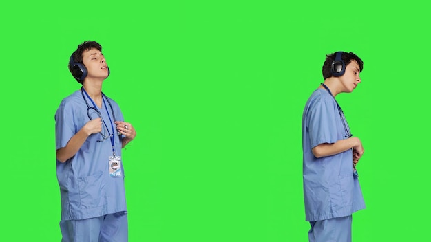 Free photo joyful nurse singing and dancing with wireless headphones on