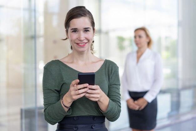 Joyful office assistant checking messenger