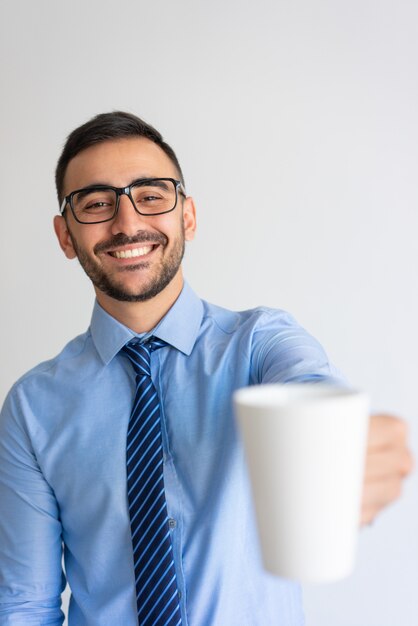 Joyful office worker offering coffee