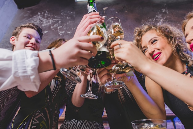 joyful people clinking glasses