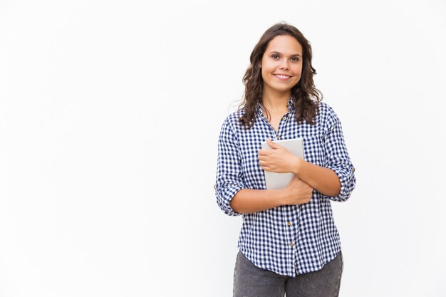 Joyful positive woman holding tablet