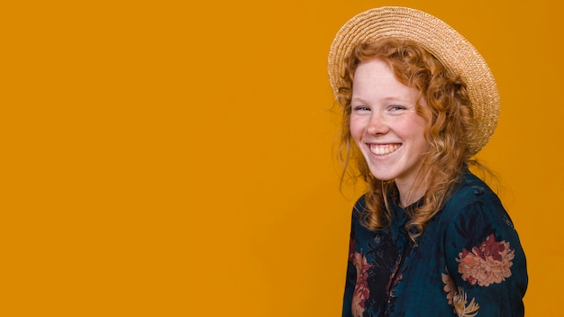 Free photo joyful redheaded female in studio with colored background