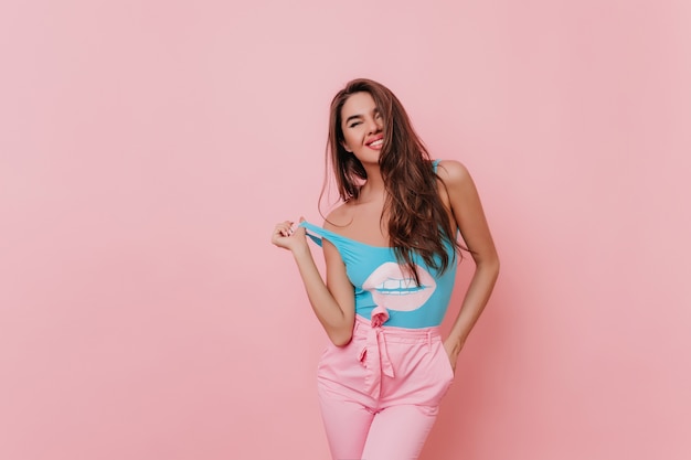 Joyful sensual girl in blue tank-top posing 