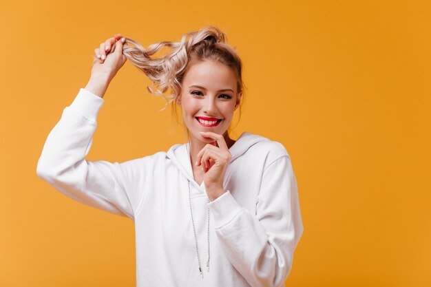 Joyful woman in anticipation of good news bites her lip