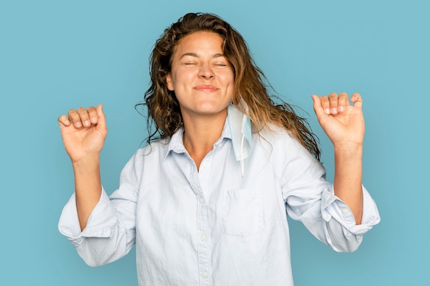 Joyful woman dancing on blue background