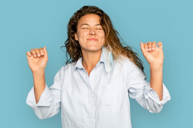 Joyful woman dancing on blue background