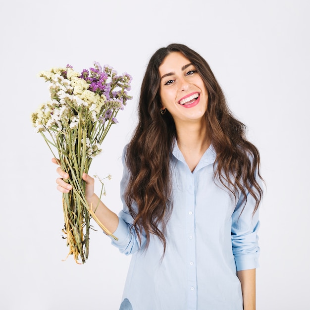 Joyful woman holding bouquet of flowers