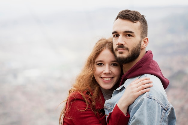 Joyful woman hugging attractive man