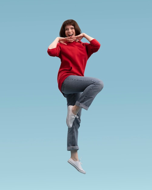 joyful woman jumping isolated on blue