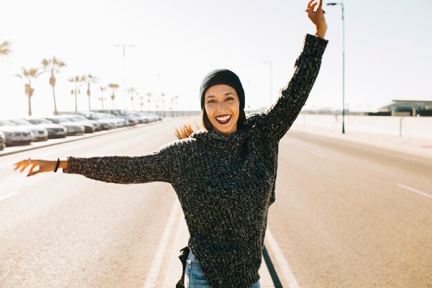 Joyful woman in middle of street