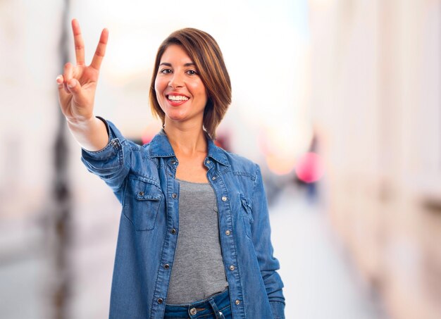 Joyful woman showing victory gesture