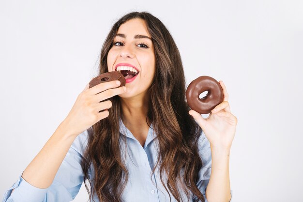 Joyful woman with donuts