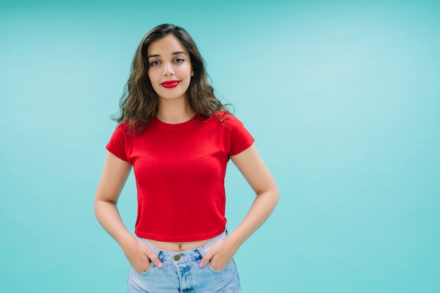 Joyful woman with hand in her pockets