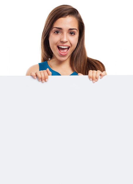 Joyful woman with long hair and an empty placard