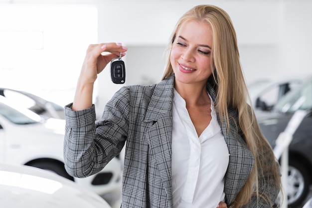 Free photo joyful women looking  at keys medium shot