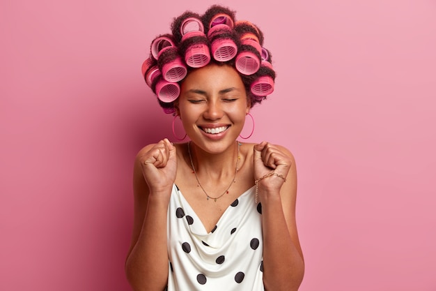 Free photo joyful young afro american woman clenches fists and celebrates something