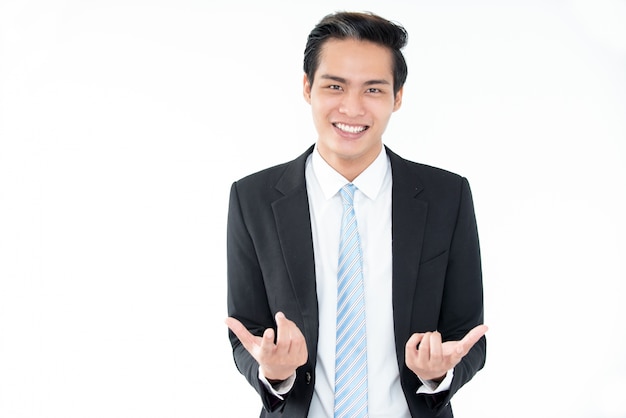 Joyful young Asian businessman gesturing