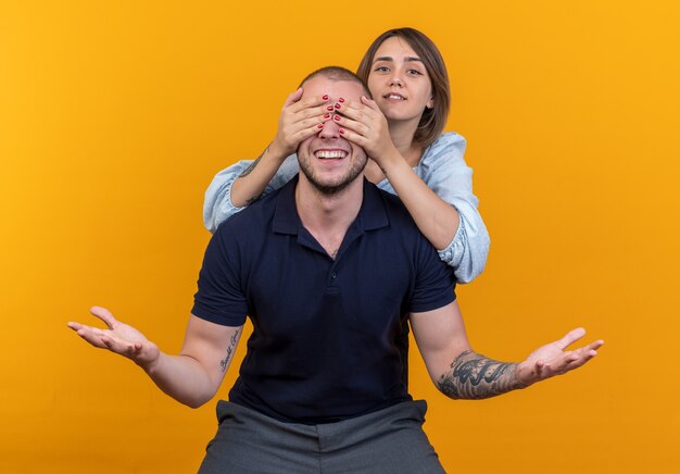 Joyful young beautiful couple man and woman happy in love having fun together while piggyback ride