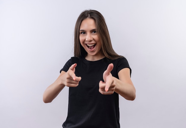 Joyful young caucasian girl wearing black t-shirt showing you gesture with both hands on isolated white wall